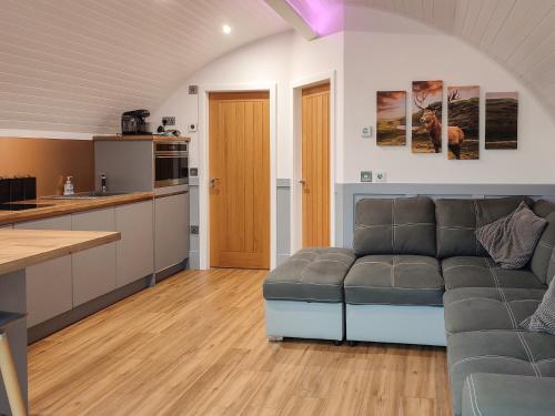 a living room with a couch and a kitchen at Ben Aigan - Ukc6027 in Newmill