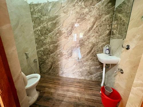 a bathroom with a sink and a toilet at 5 Star Yatri Vishram AC & Non AC Dormitory in Jabalpur