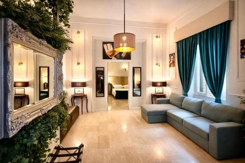 a living room with a couch and a mirror at Spanish Steps Boutique Hotel - Madame Sofia Secret Hotel in Rome