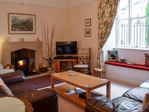 a living room with a couch and a fireplace at The Old King's Head Pickering in Pickering
