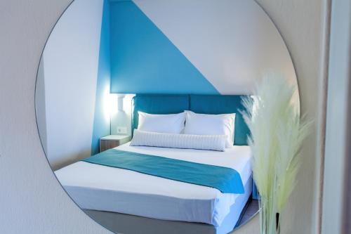 a bedroom with a bed in a mirror at Maistrali Beach Studios in Gerakini