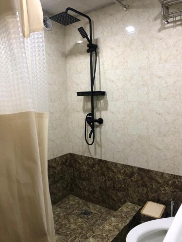 a bathroom with a shower with a sink and a shower at Secret Garden in Dushanbe