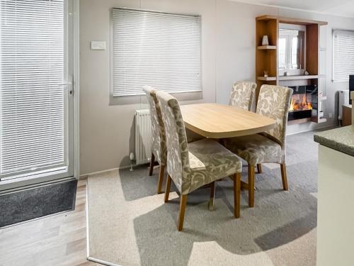 a dining room with a wooden table and chairs at The View in Stranraer