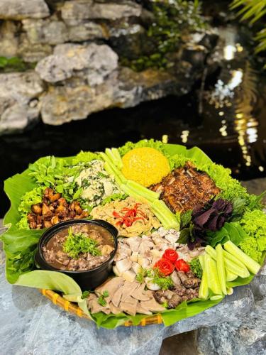 a plate of food with a variety of foods on it at KDL Pauon Ecolakes in Quỳnh Nhai