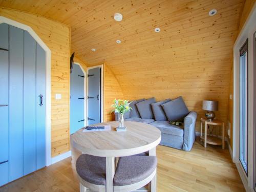 a living room with a table and a couch at Dougie's Pod in Acharacle