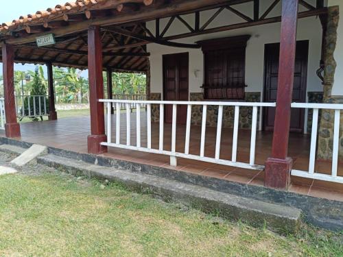 a porch of a house with a wooden deck at Quinta Campestre Bella Vista in Acacías