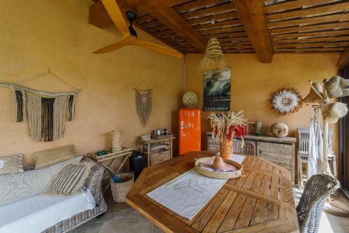 a living room with a table and a couch at Mas de l'Olivette in Cotignac
