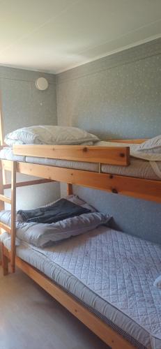 a bedroom with two bunk beds in a room at Black Pearl in Höjaholm