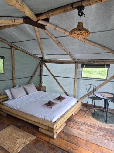 a bedroom in a tent with a bed and a table at Bamboo glamping in Kotor