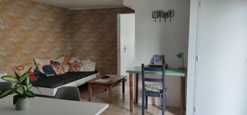 a living room with a couch and a table at Appartement Saint Sulpice la Pointe in Saint-Sulpice