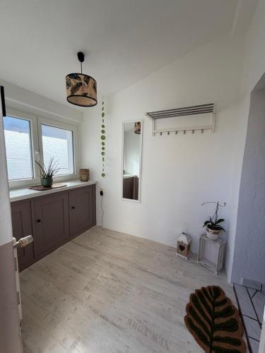 a living room with white walls and wooden floors at Dianas Ferienwohnung 2 in Feldberg