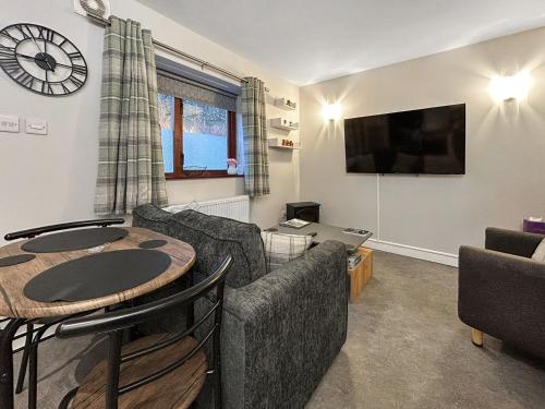 a living room with a couch and a table at The Lade in Kilsyth