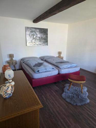 a bedroom with two beds and a coffee table at Apartmán na statku NH Stables in Nýřany