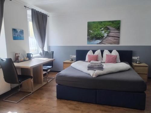 a bedroom with a blue bed with a desk and a desk at Ferienhaus Kolbnitz in Unterkolbnitz