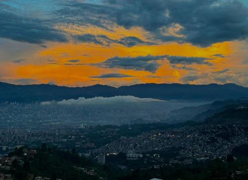 a view of a city under a cloudy sky at Hostal Del Cielo in Medellín