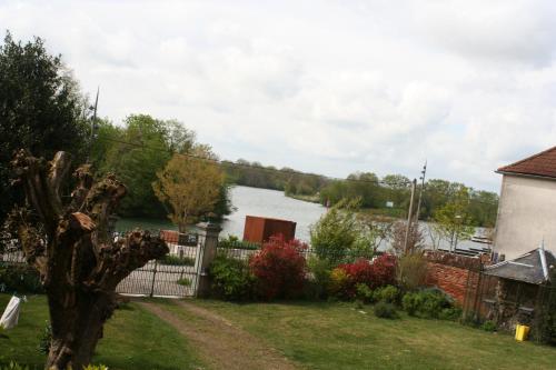 a view of a lake from the yard of a house at Manoir de la Saône in Seurre