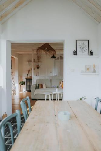 a living room with a wooden table and chairs at L'envol des oies in Braives