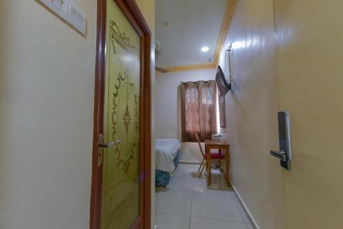 a hallway with a door leading to a bedroom at SMC Hotel Alam Avenue in Shah Alam