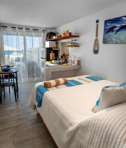 ein Schlafzimmer mit zwei Betten und eine Küche mit einem Tisch in der Unterkunft Beach Front Lux Containers in La Ventana