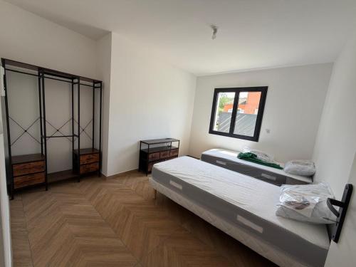a room with two beds and a window at Villa eger in Ruoms