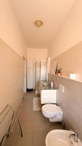 a bathroom with a toilet and a sink at La casa al mare in Grottammare