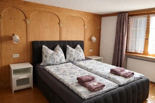 a bedroom with a bed with two pillows on it at Hotel Bären Amriswil in Amriswil