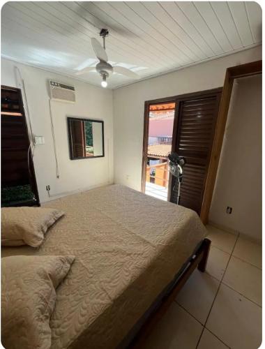 a bedroom with a large bed and a window at Recanto da harmonia in Ribeirão Preto