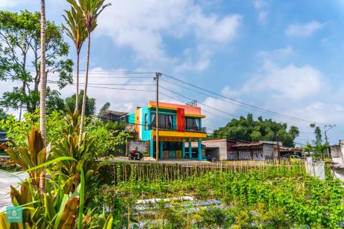 a colorful building on the side of a street at INSTAY Hotel Dieng Chill Serenity in Garung