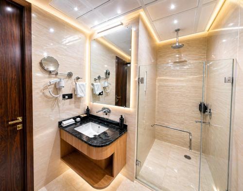 a bathroom with a sink and a shower at Hotel avadh classio near by ram mandir in Faizābād