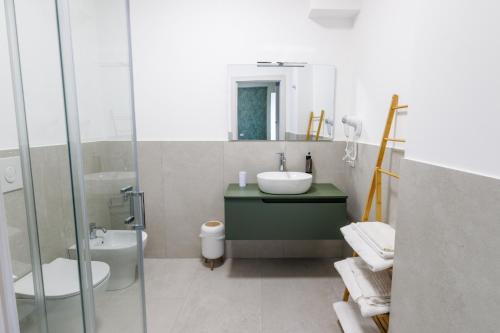 a bathroom with a sink and a toilet at HARBOR BREEZE Trapani in Trapani