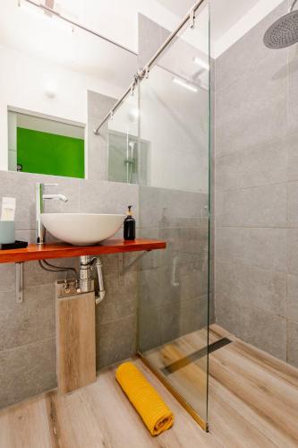 a bathroom with a sink and a glass shower at Beach LOFT Tabaiba in Tabaiba