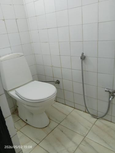 a bathroom with a toilet and a shower at Cabanon plage david in Bouznika