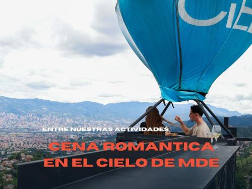 a couple sitting at a table in a hot air balloon at Hostal Del Cielo in Medellín