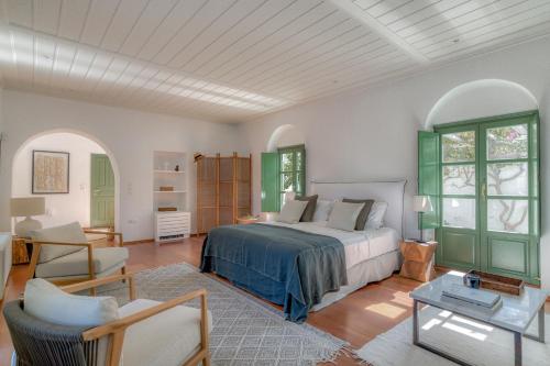 a bedroom with a bed and a living room at Villa Thimari in Protorgia