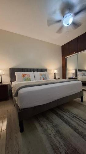 a bedroom with a bed with a ceiling fan at Sea View Escape in The Valley