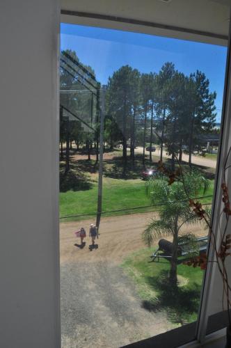 a window view of two children walking down a dirt road at Los Abus in Colón