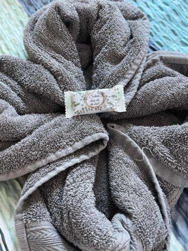 a gray towel with a tag on top of it at Haus Kormoran Borkum in Borkum