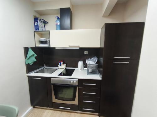 a small kitchen with a sink and a stove at Apartment in the Center 1 in Varna City