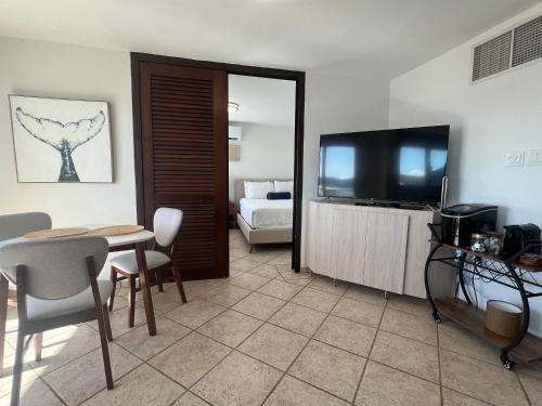a living room with a table and a television at Seaside Villa Culebra in Culebra
