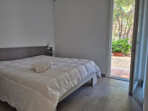 a bedroom with a bed and a sliding glass door at Pitagora Residence in Metaponto