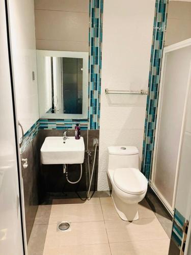 a bathroom with a toilet and a sink at Landed IOI City Mall Country Heights Putrajaya Homestay in Kajang