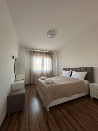 a bedroom with a large bed and a window at Prime Rooms Tirana in Tirana