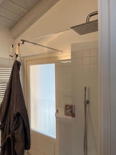 a bathroom with a shower and a window at Dream View Lake Como in Carate Urio