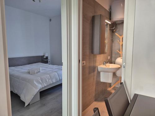 a bedroom with a bed and a sink at Pitagora Residence in Metaponto