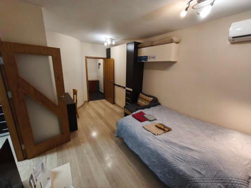 a small room with a bed and a door at Apartment in the Center 1 in Varna City