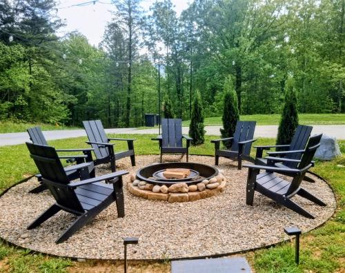 four chairs around a fire pit in a yard at Grizzly Glam in Gatlinburg