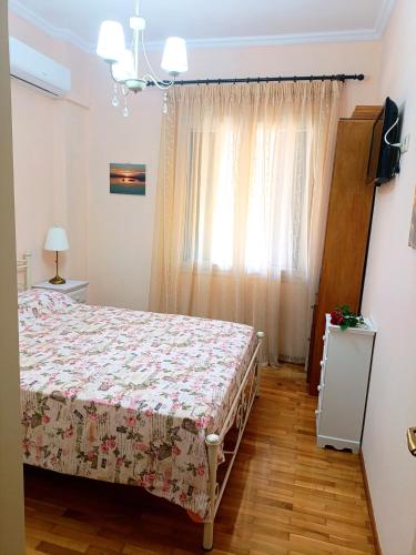a bedroom with a bed and a window at Maira's place Corfu in Corfu