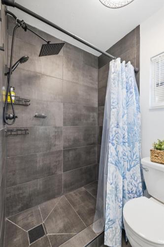 a bathroom with a shower and a toilet at Clearwater Paradise w Hot Tub-Backyard Bliss Near Beach & Hot Spots in Clearwater