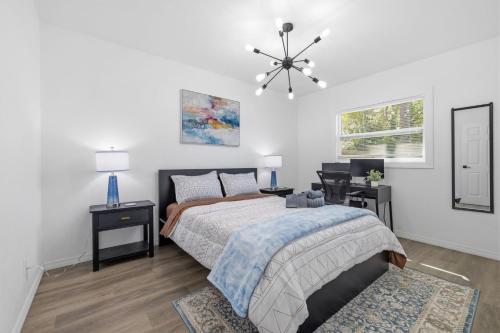 a bedroom with a bed and a desk and a window at Clearwater Paradise w Hot Tub-Backyard Bliss Near Beach & Hot Spots in Clearwater