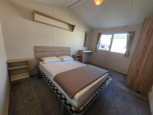 a bedroom with a large bed in a room at Merryfield and Sandfields in Chapel Saint Leonards